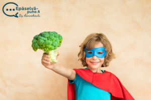 Lapsi pukeutunut supersankariksi ja pitelee parsakaalia kädessään